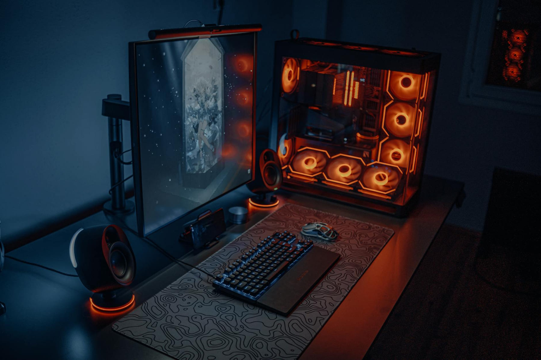 Sleek gaming desk setup featuring RGB lighting, large monitor, and gaming PC with glowing fans. on Frame Rate Vault