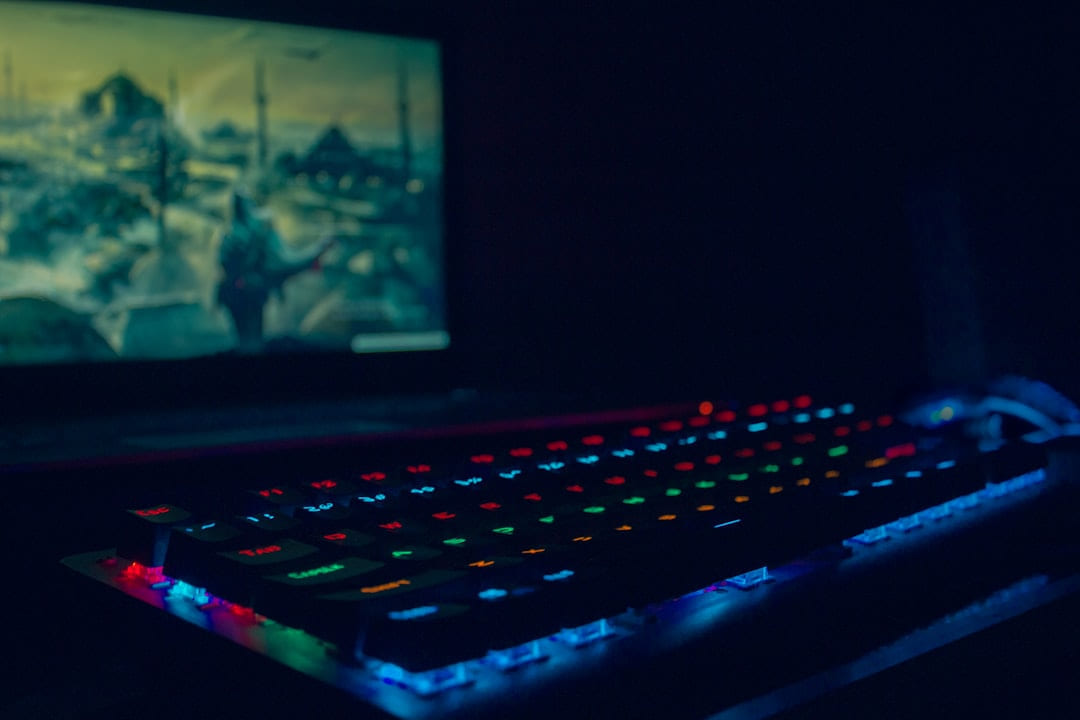 black laptop computer turned on with blue lights on Frame Rate Vault
