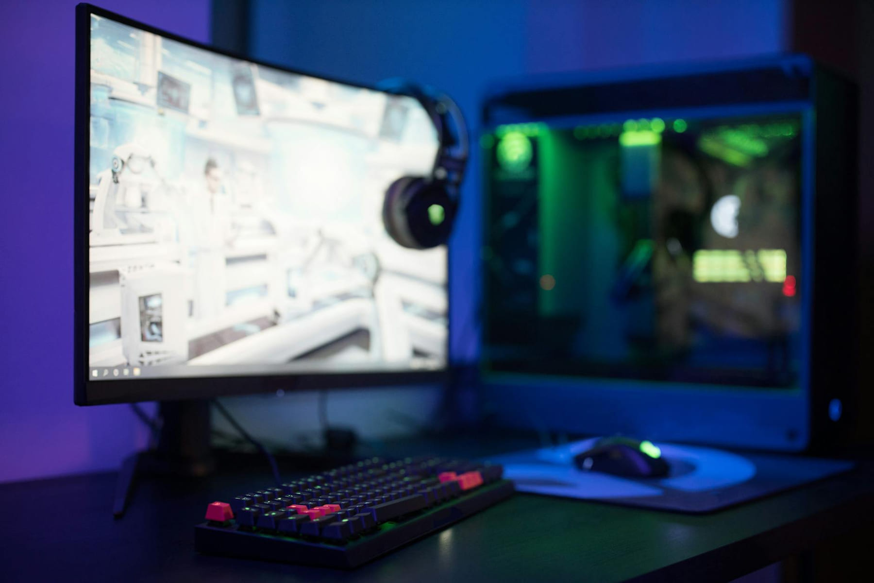 High-tech gaming setup featuring a curved monitor, RGB keyboard, and vibrant lighting. on Frame Rate Vault