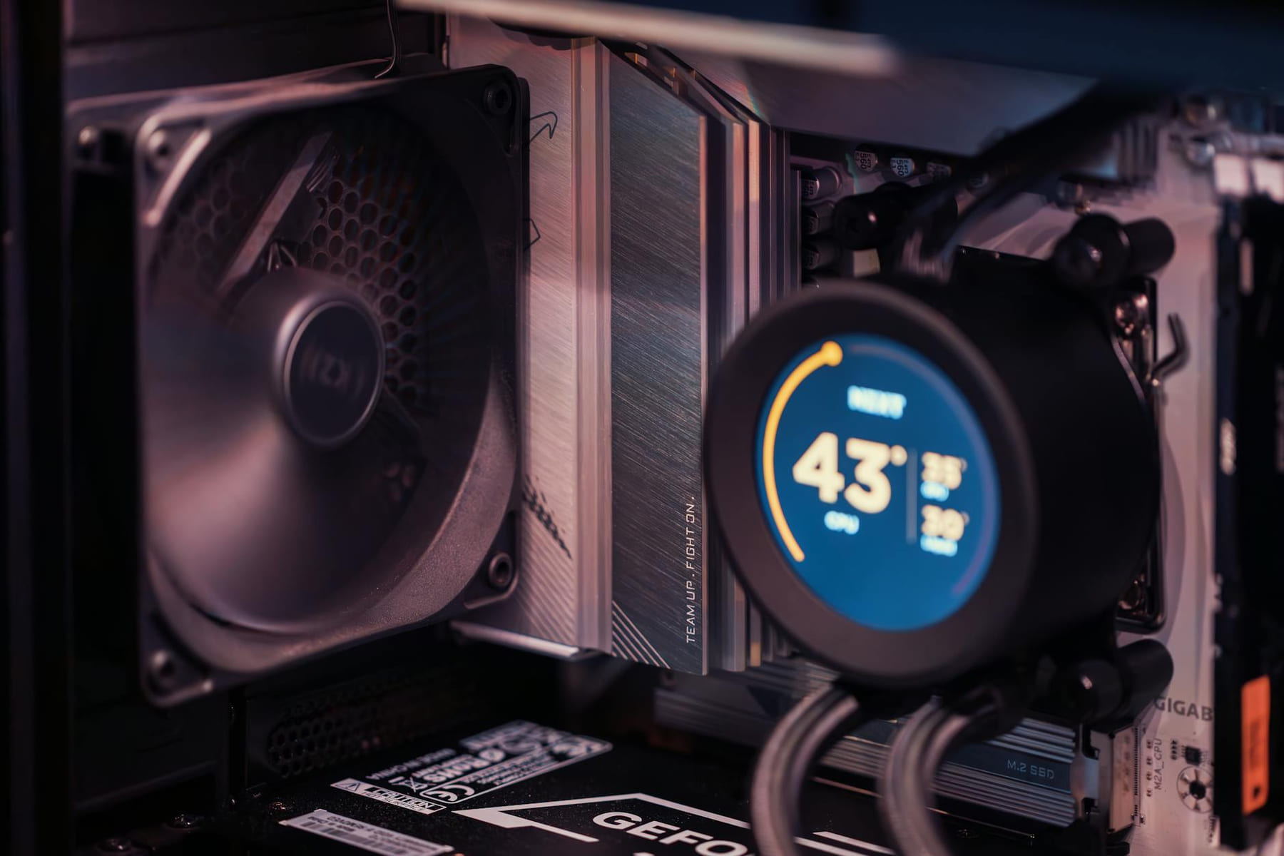 Close-up of a gaming PC build showcasing GPU, fan, and liquid cooling system. on Frame Rate Vault