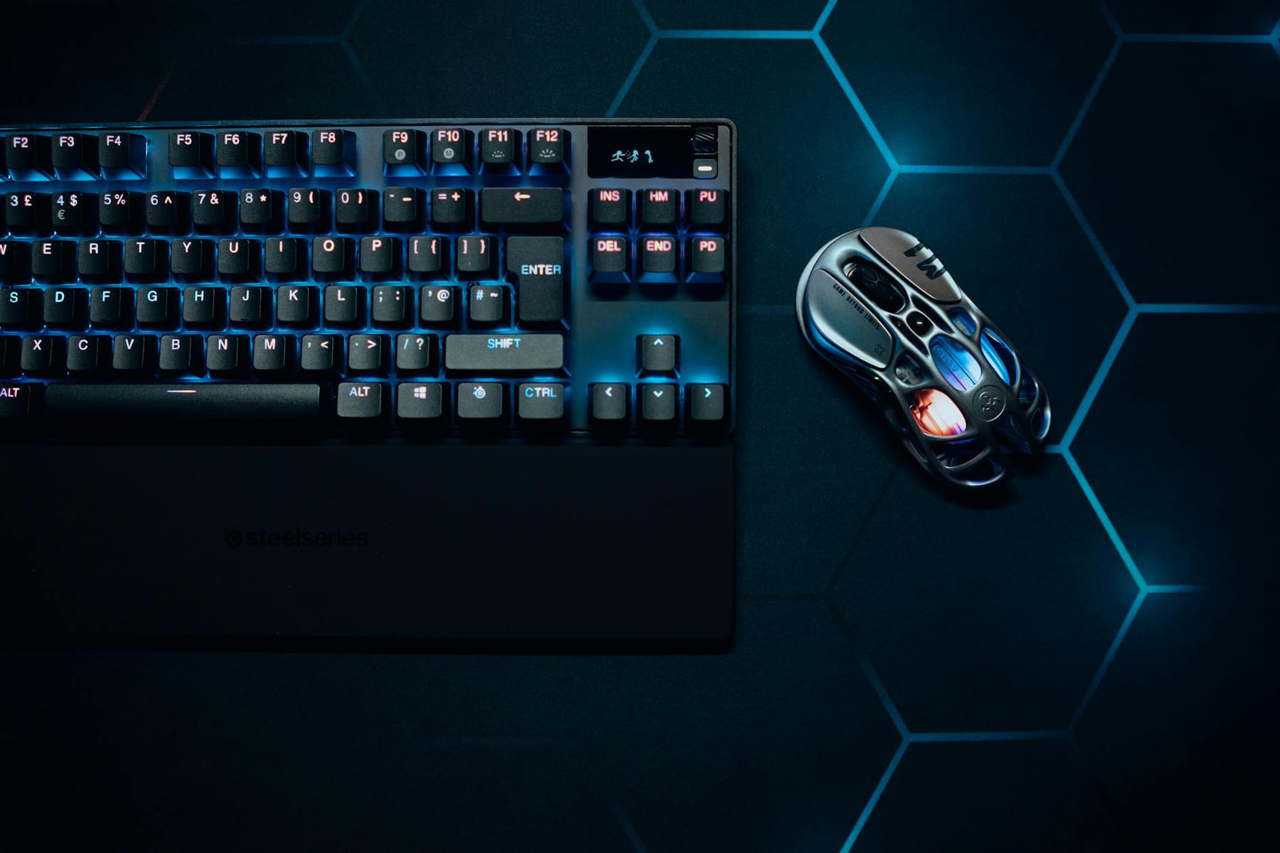 Stylish RGB gaming keyboard and mouse with vibrant lighting, perfect for tech enthusiasts. on Frame Rate Vault