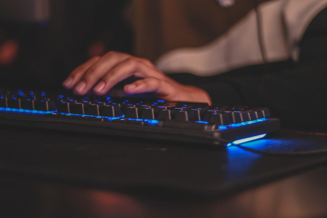 person holding gaming keyboard on Frame Rate Vault