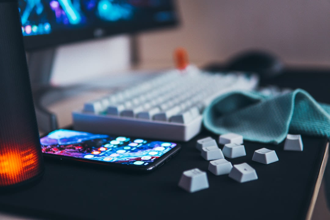 black Android smartphone beside keyboard and monitor on Frame Rate Vault
