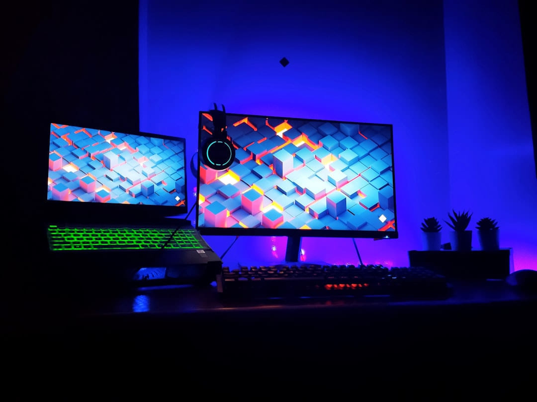 two computer monitors sitting on top of a desk on Frame Rate Vault